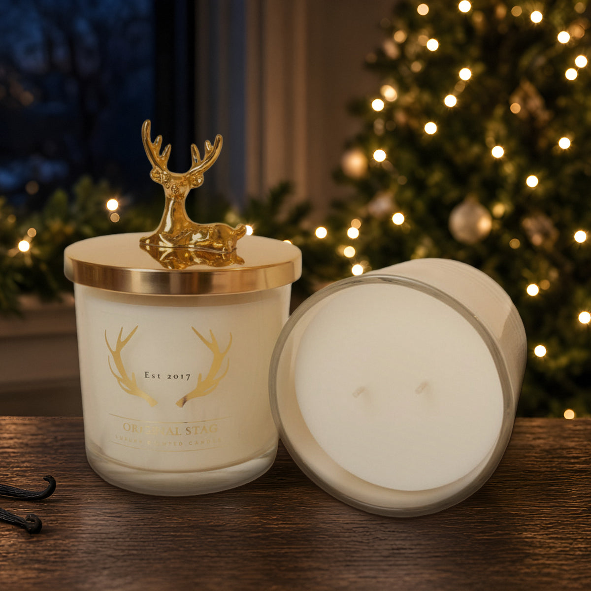 Midnight Orchid double wick scented candle with gold stag lid in a Christmas setting