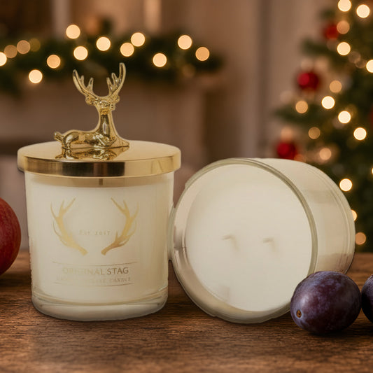 Pomegranate & Plum double wick scented candle with gold stag lid in a Christmas setting